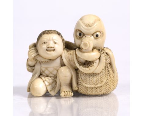 A Japanese ivory netsuke of a youth late Meiji seated beside a fisherman's basket upon which an octopus emerges wrapping feel