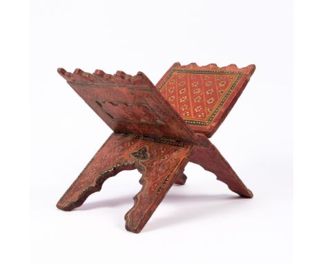 An Indian polychrome painted manuscript stand 19th Century decorated with patterns and carved details, 27.5 cm across