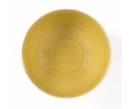 A Chinese yellow monochrome bowl 18th/19thCentury with central flower head, Qianlong seal mark 11.75cm