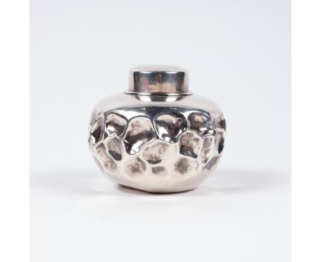 A Japanese silver metal tea caddy and cover Meiji period of irregular beaten form, 8cm high, 149 grams