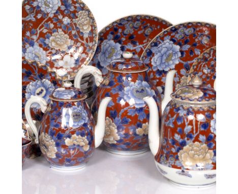 A Japanese Fukagawa tea and coffee service early 20th Century of iron red ground, decorated with chrysanthemum and birds 