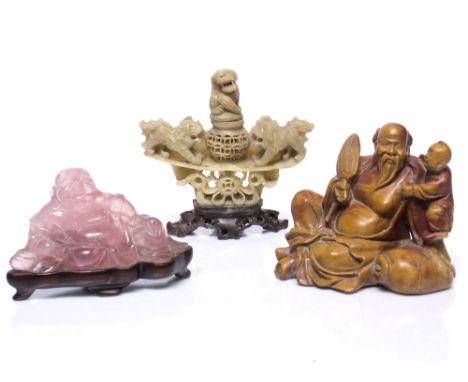 A Chinese rose quartz figure of Putai  5cm x 10cm on a fitted wooden stand, a soapstone figure of Li Peh seated beside a fall