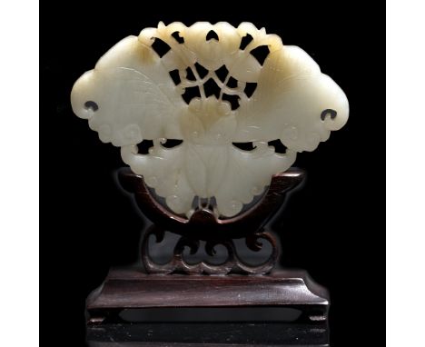 A Chinese white jade plaque  19th Century pierced and carved as a butterfly and lotus flower on wood stand, 9cm x 6.8cm