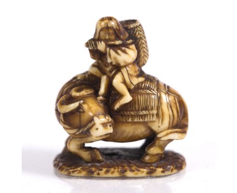 A Japanese netsuke of Roshi late Meiji seated upon an ox playing a flute, on a shaped base, 3cm long