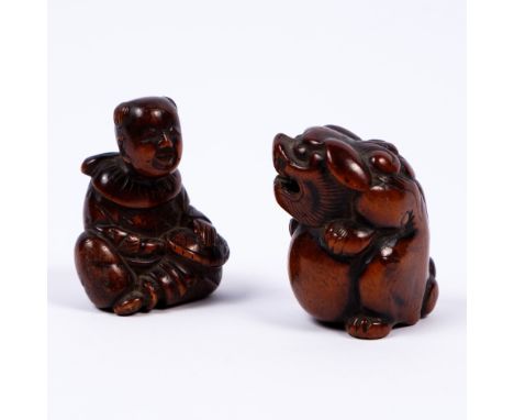 A Japanese wood netsuke of a seated shi shi and ball Kyoto School 19th Century and a seated karako with tortoise, signed Kazu