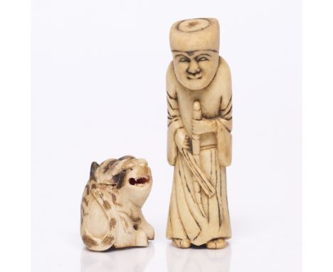 A Japanese ivory netsuke 19th Century carved in the form of a figure with a fly whisk, 9cm and one other carved tiger netsuke