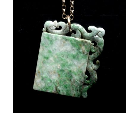 A Chinese jade pendant the rectangular panel with scroll carved border on a belcher-link chain with clasp stamped 'sterling',