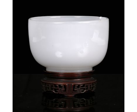 A Chinese Beijing glass bowl 19th Century imitating jade on a hardwood stand, 11cm across x 8cm high Provenance:  Bought in t