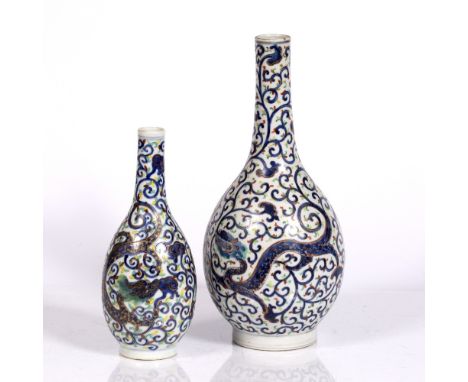 A Chinese bottle vase dragon and scroll designs, 36cm and a similar smaller vase, 26cm