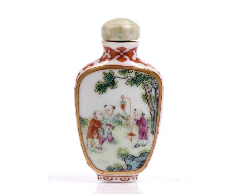 A Chinese famille rose spade form snuff bottle decorated with gilt framed panels depicting boys at play in a garden setting, 