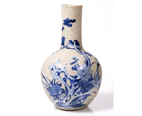 A Chinese blue and white porcelain bottle vase 19th Century decorated with birds and flowering branches with raised edith dec