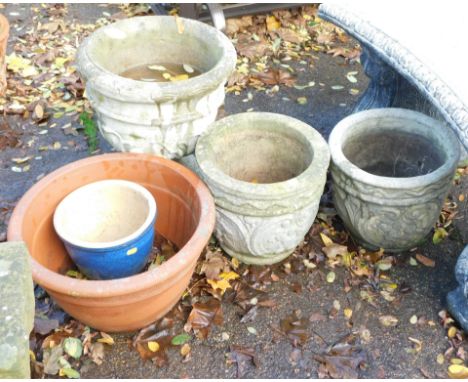 A collection of garden planters, comprising a reconstituted stone urn, 44cm high, a pair of crested planters, 35cm diameter, 