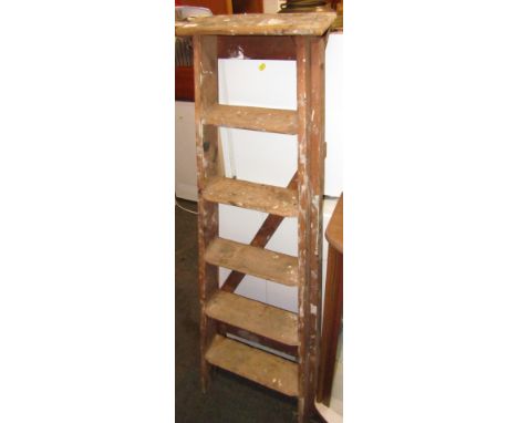A wooden five rung step ladder.