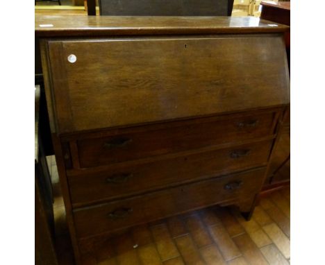 Oak bureau with three drawers under writing shelf