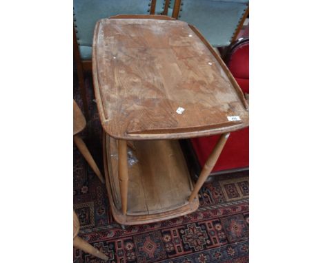 An Ercol light elm drinks trolley, of traditional design, bearing Ercol label, damage to central tier.