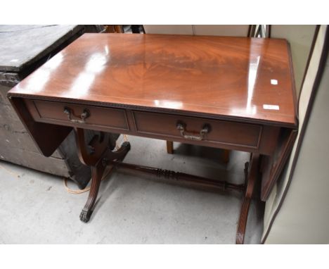 A reproduction Regency sofa style table having drop ends and metal claw feet