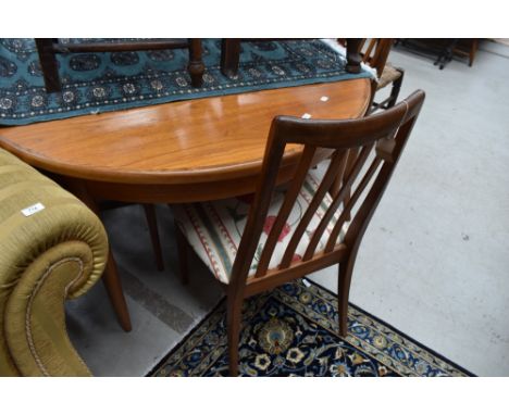 A vintage teak G plan circular dining table and set of four railback dining chairs