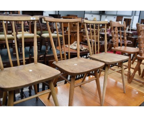 A group of three Ercol style elm seated stick back chairs.