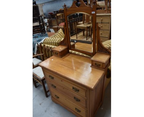 A late Victorian dressing table with chest of three drawers having bevel edged mirror