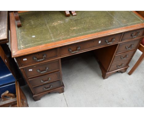 A reproduction twin pedestal mahogany desk.