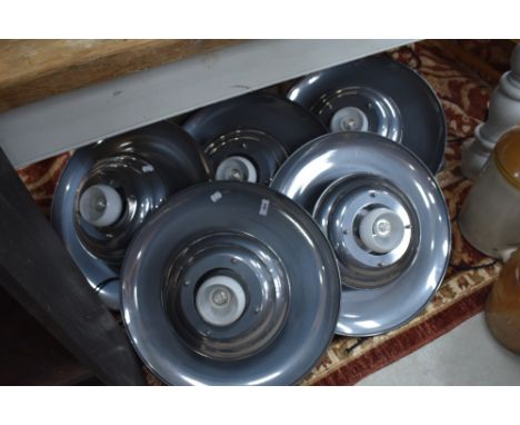 A group of five mid century design circular pendant light fittings, each with small globular central opaque glass shade.