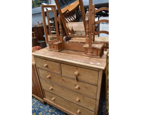 A stripped pine Victorian chest of two over three drawers and later natural pine dressing table mirror