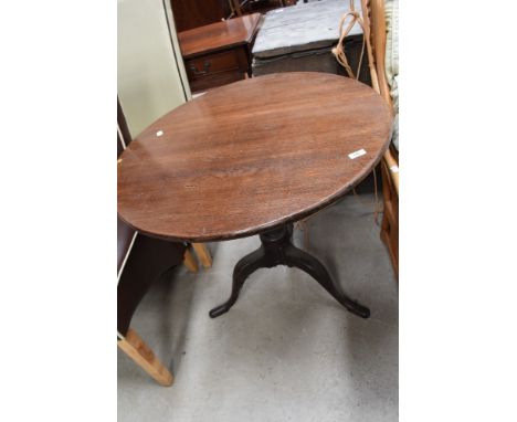 A 19th Century oak pedestal table having circular top, turned column and triple splay legs