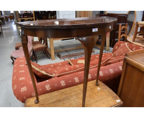 An early to mid 20th Century walnut demi lune hall table on cabriole legs