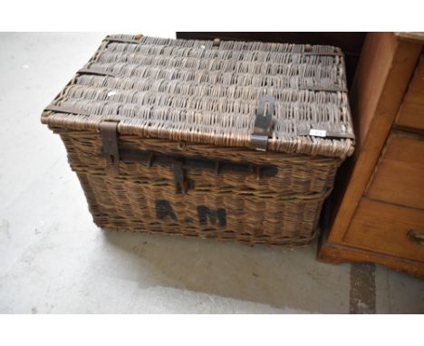 A large late 19th/early 20th century woven wicker hamper with metal straps and locking mechanism, the interior with lift-out 