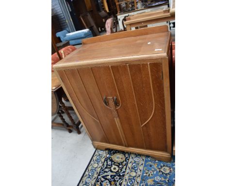 A 20th century light oak utility cupboard