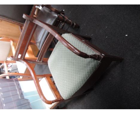An early 20th century mahogany armchair commode in the Regency style having rail back