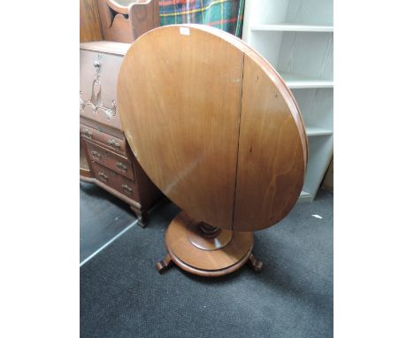A mid Victorian light mahogany centre table having circular top on bulbous pedestal with circular platform base and triple sp