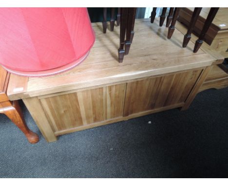 A wooden, light oak panelled blanket box
