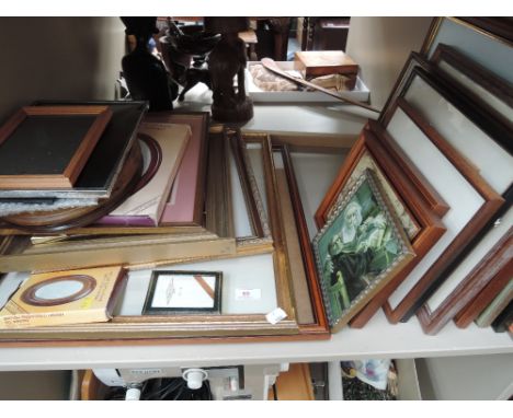 A shelf of various pictures and frames