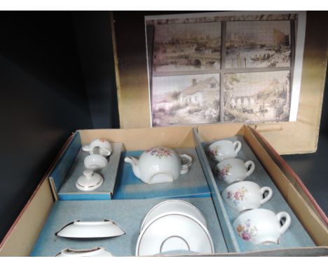 A child's tea set and four vintage jigsaws