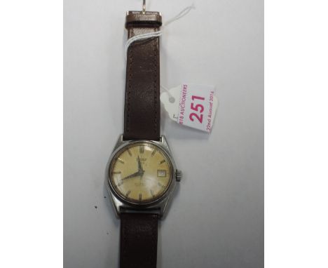 A gents Tissot T12 automatic visodate wrist watch having a baton numeral dial and date aperture to face, engraved ship to rev