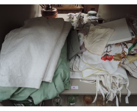 A shelf of vintage linen and silk headscarfs