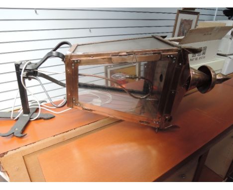 A copper Victorian street style wall light, having black wrought iron bracket