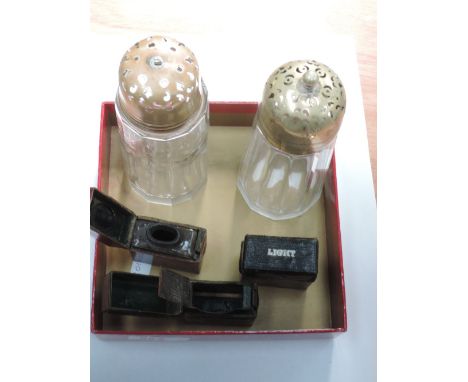 Two vintage travel lights in leather covers, a leather bound travel ink well and two two glass sugar casters