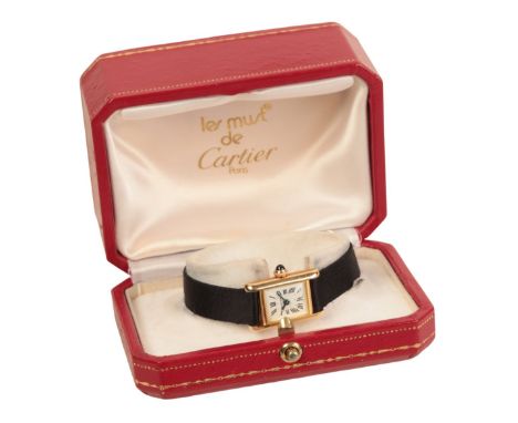 CARTIER: A LADY'S 18CT GOLD WRISTWATCHwith manual wind movement, the white enamel dial with black Roman numerals and dark blu