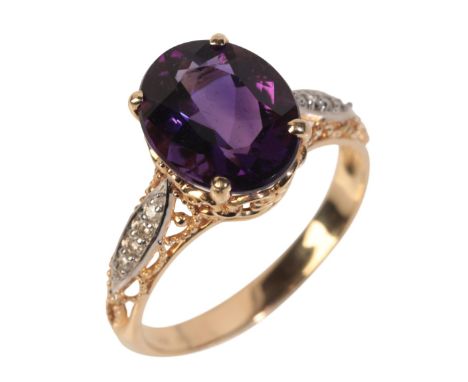 A 14CT GOLD AMETHYST AND DIAMOND RINGset with an oval cut amethyst over rope work shoulders set with round brilliant cut diam