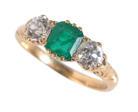 A VICTORIAN EMERALD AND DIAMOND RINGset with a central rectangular-cut emerald flanked by old brilliant-cut diamonds, on a ye
