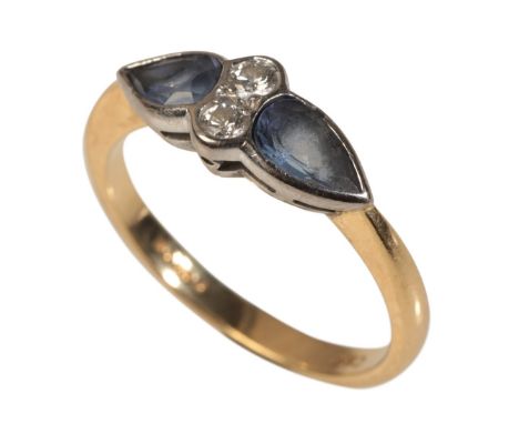 AN 18CT GOLD TANZANITE AND DIAMOND RINGset with two pear shape tanzanites, totalling c.0.60 carats, flanking two round cut di