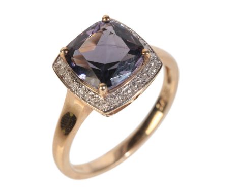A 9CT GOLD TANZANITE AND DIAMOND RINGthe central cushion cut tanzanite surrounded by a halo of diamonds, the ring head approx