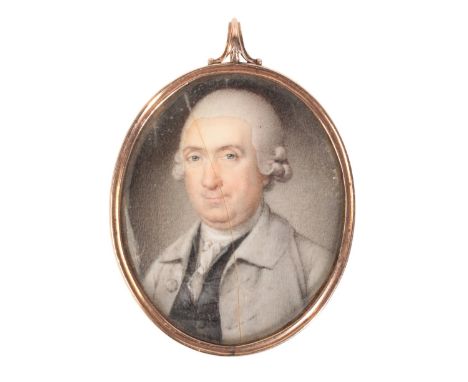 A PORTRAIT MINIATURE OF AN 18TH CENTURY GENTLEMANin a grey coat and powdered wig, painted on ivory, in a yellow metal setting
