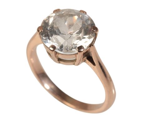 A WHITE SAPPHIRE SOLITAIRE RINGset with a round cut white sapphire c.3.00 carats, gold coloured metal setting, ring size M