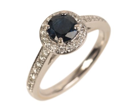 AN 18CT WHITE GOLD SAPPHIRE AND DIAMOND HALO RINGset with a round cut blue sapphire measuring approx. 5.43mm, c.0.70 carats, 