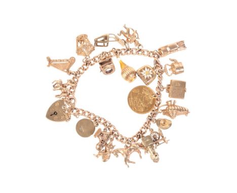 A 9CT GOLD CURB LINK CHARM BRACELETwith traditional heart shaped padlock, the chain assayed on every link for London 1963, th