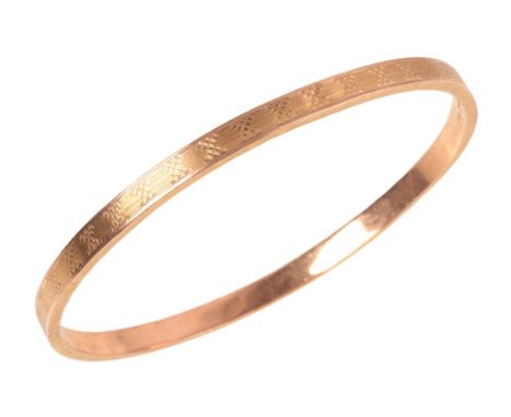 A 9CT GOLD BANGLEthe hollow bangle with engine turned engraving to the face and sides, hallmarked 'H.G & S' Chester '9.375' 1