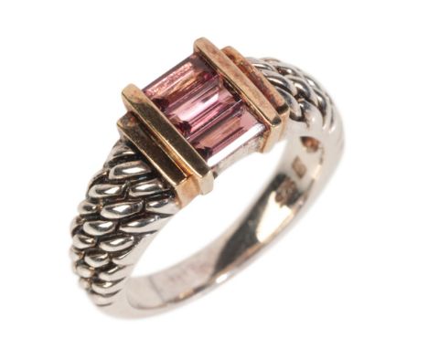 A DAVID YURMAN STYLE SILVER TOURMALINE RINGset with three step cut pink tourmaline set in yellow metal with corn row pattern 